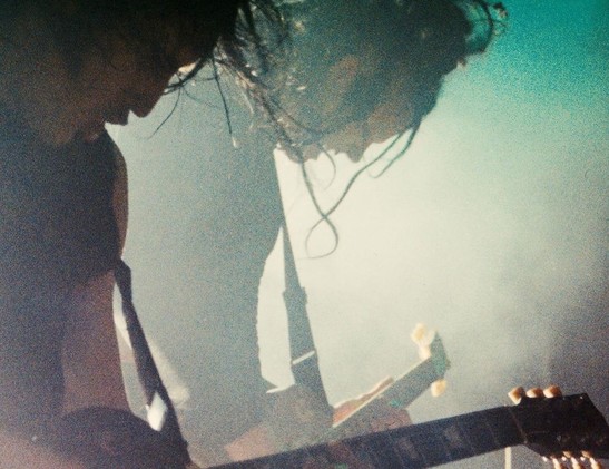 Trent Renor and nin guitarist Robin Finck onstage, in color, gritty and smoky and drenched in sweat with hair flying everywhere, shredding on guitars, in one of the most badass photographs I've ever fucking seen