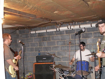 The Retro Delicatessen play in a Maryland basement, one of my old bands. Jesse Davis on the left on guitar, Joe Rankin on drums, me on bass. 