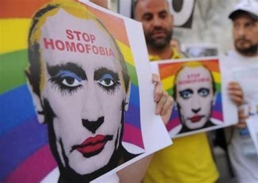People protesting with signs that show Putin with makeup on a rainbow flag