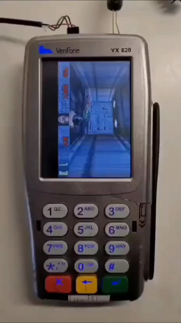 Doom being played on a credit card terminal. The buttons fire and move the player. When a credit card us swiped, the door opens. 
