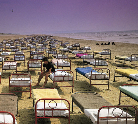 The cover/sleeve art from Pink Floyd's 1987 album 'A Momentary Lapse of Reason' which is a dude sitting on a bed in a line of what I found out was 700 beds they set up near the beach in Los Angeles. Absolutely no photo trickery was used, this was really set up.