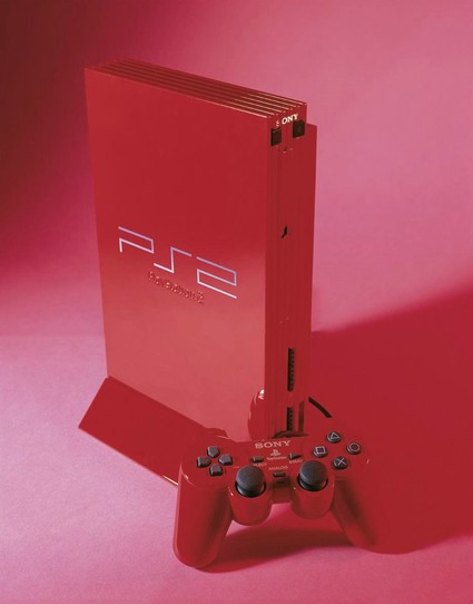 The red console and controller of the Automobile Color Collection Sony released in 2001 to commemorate the sale of the 20 millionth PS2 console sold worldwide.