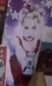 Low resolution closeup from the first image. One woman. 90s music presumably