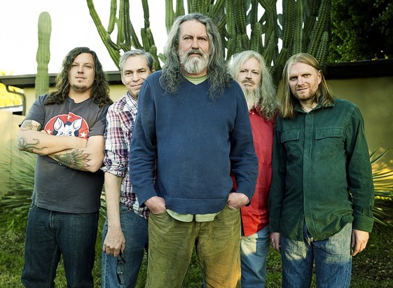 Current Meat Puppets lineup. From left to right, Curt's son Elmo on far left, then original drummer Derrick who is now back, Curt and Cris Kirkwood, and new keyboard player Ron Stabinsky. All standing outside in Arizona in front of a bunch of cactus.