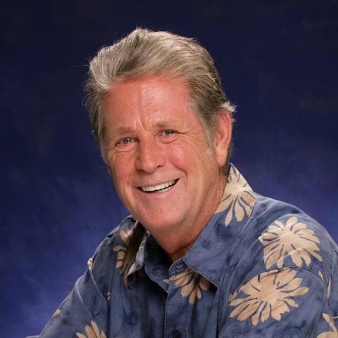A photo of Brian in his later years, color, blue background 