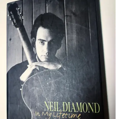 The front of the Neil Diamond 'In My Lifetime' box set with an early pic of Neil holding a guitar