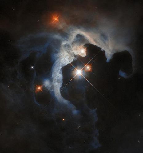 This Hubble image shows GN 04.32.8, a reflection nebula some 480 light-years away in the constellation of Taurus. The color composite was assembled from images taken in visible and near-infrared light. It is based on data obtained through two filters. The color results from assigning different hues to each monochromatic image associated with an individual filter. Image credit: NASA / ESA / Hubble / G. Duchêne.