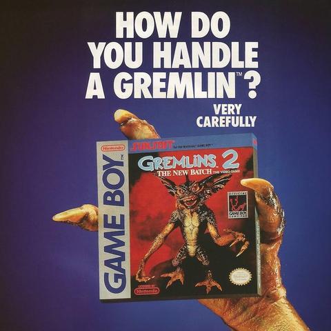 Ad for Game Boy game Gremlins 2 with a gremlin hand holding it, and it says 'how do you handle a gremlin?' (Very carefully) 